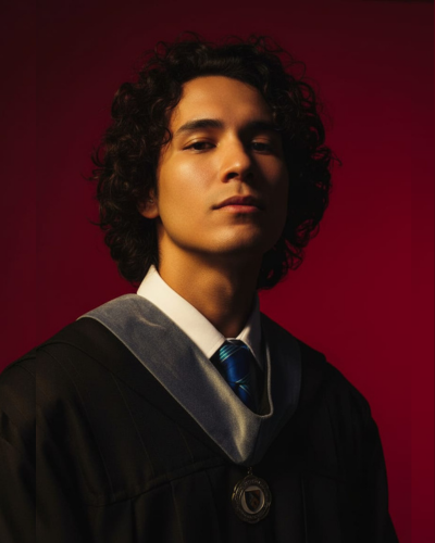 A man wearing a safety helmet and work uniform, holding electrical tools and working on a control panel in a technical workspace. The background shows cables and equipment, conveying a focused and professional atmosphere.